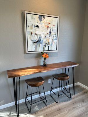 Beautiful wood counter height table and 2 comfortable wood seat stools.