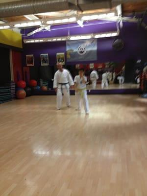 Black belt David O'Keffe teaching yellow belt Luisa.