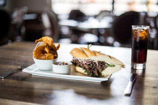 Braised Shortib Sandwich & Spiral Fries: arugula, tomato, bleu cheese, fresh horseradish, roasted garlic aioli, french roll.