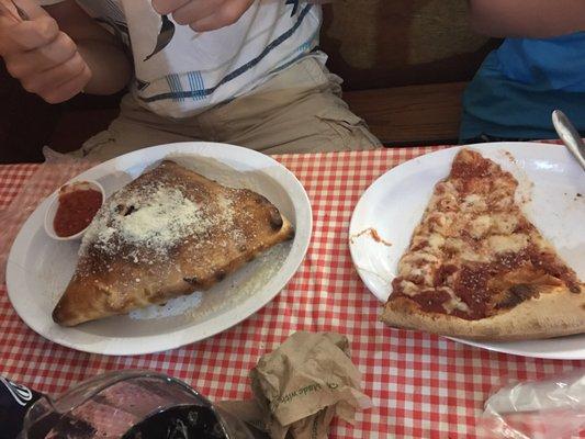 Huge calzone and slice of cheese