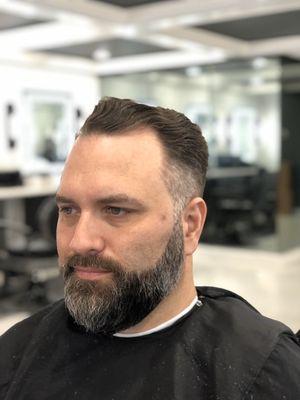 Classic cut with the top slicked back and beard lined up.