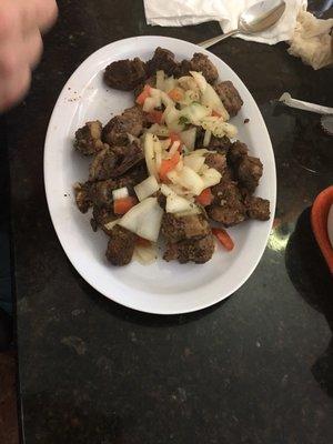 The visitors enjoyed this goat stew, literally to the bone.