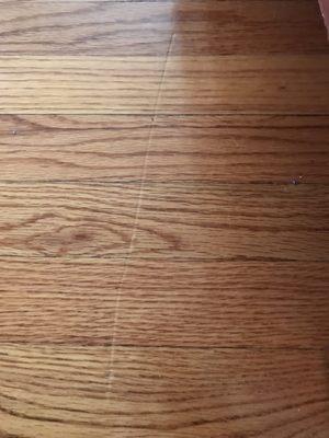 Huge scratch in my floor caused by their movers!