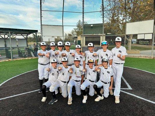 TBI 12U displaying their hardware after winning a championship game in Simi.