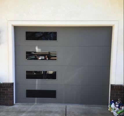 Installed an Flush Panel collection garage door in graphite color and tinted glass.