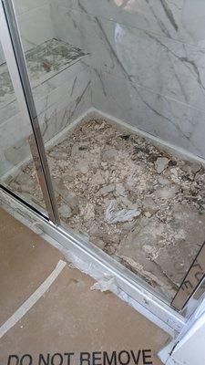 Moldy drywall that had attracted flies is still in the shower and tubs 4 months later.