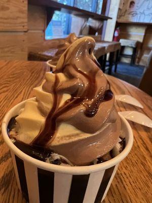 Chocolate vanilla swirl with coconut flakes, butterfinger and chocolate sauce