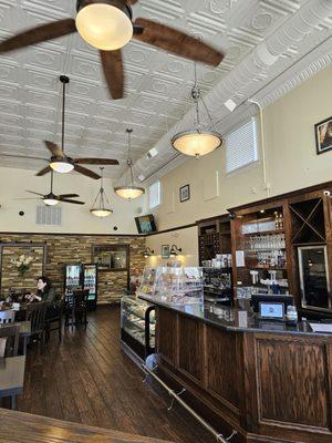 The inside of the entire restaurant; with the ceiling fans and lamps.