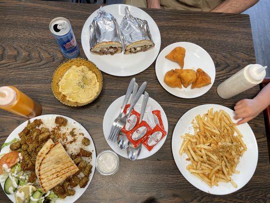 The spread--falafel plate, garlic fries, hummus, samosas, and stick cheese sandwich.