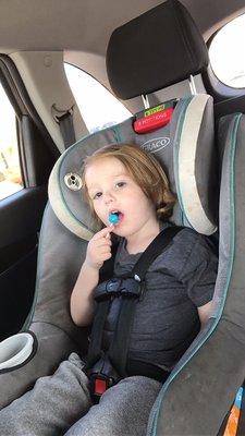 Happy with his quick and easy haircut and loves his lollipop