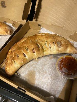 My brothers calzone. All 3 are different sizes with the same toppings.