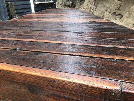 Deck refinished and treated with linseed oil and sealant.