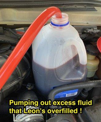 Other mechanic pumping out the excess fluid that Leon's installed after dropping transmission pan.  Excess fluid can damage a transmission.