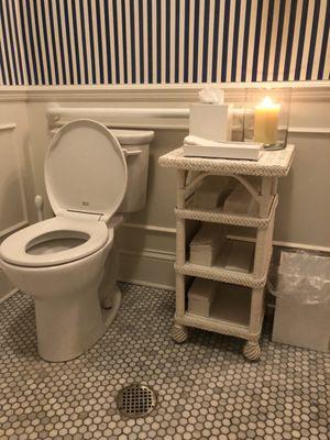 Clean restroom for customers with lit scented candle