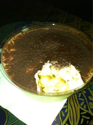 Delicious tiramisu (round bowl ~4in in diameter?)!! The lighting is dim to prob set the mood...