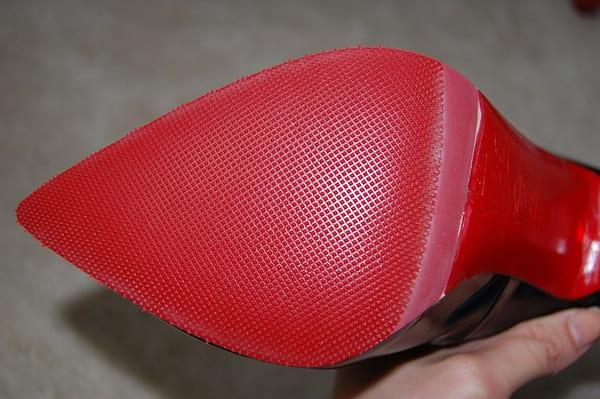 The rubber sole was put on ok, but notice the color is a little off, and it kind of cut into the logo.