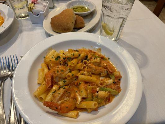 Front: Jumbo shrimp, lump crab meat and asparagus over gluten free penne in cognac tomato cream sauce.  Back: Heart shaped bread.