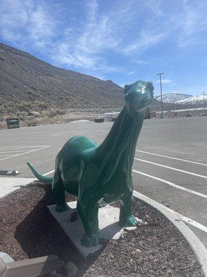 A dinosaur statue outside the store