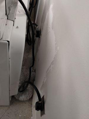 Dryer ductwork covered in debris and improper sheetrock repair. Fire hazard