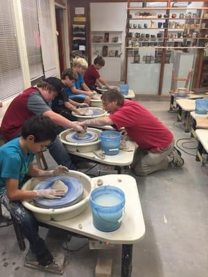 Bob Raymond teaching youth on the wheel.