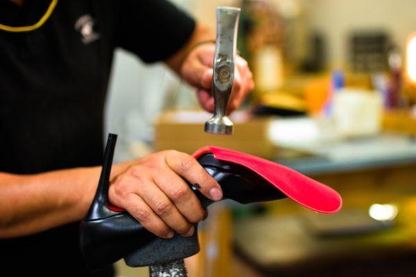 Applying the red sole protector to Christian Louboutin heels.