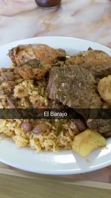 Stewed beef and chicken over rice and beans