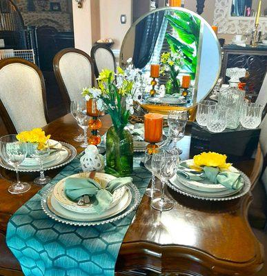 The table is decorated  with China and crystal stemware.  It is ready for a night entertainment and socializing.