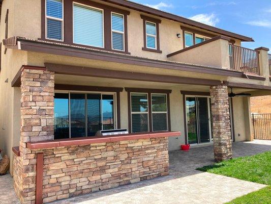 Porcelain tile patio, BBQ Island and bar with concrete countertop and veneer stone columns