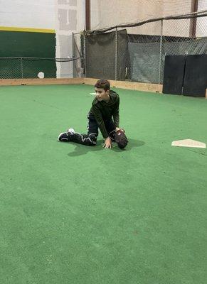 12 year old baseball catching learning to throw from his knees.