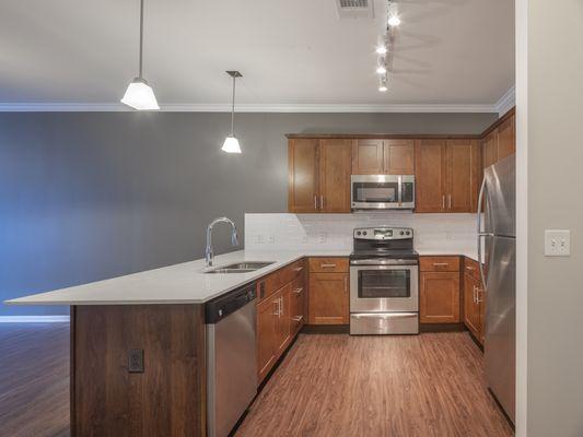 Oaks Centropolis Kitchen with granite counter tops and stainless steel appliances.