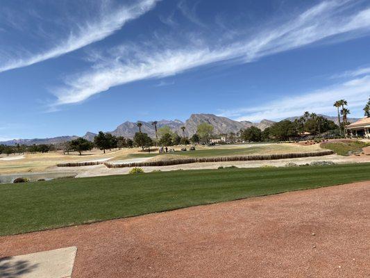 On the 10th tee box, 18th green with the mountains in the background.