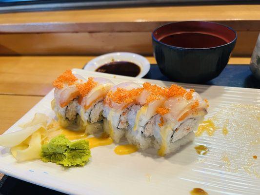 Can't remember the name of the roll, but it has shrimp tempura topped with smoked salmon, scallops and roe with a spicy sriracha mayo.