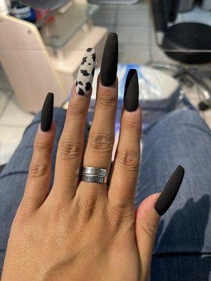 Matte cow print & black coffin shaped nails done by Danny