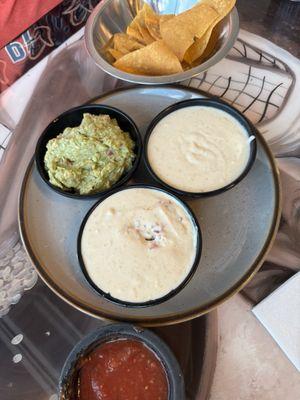 Dip trio - guacamole, cheese dip and Nixtamal dip (has ground beef and pick in the cheese dip)