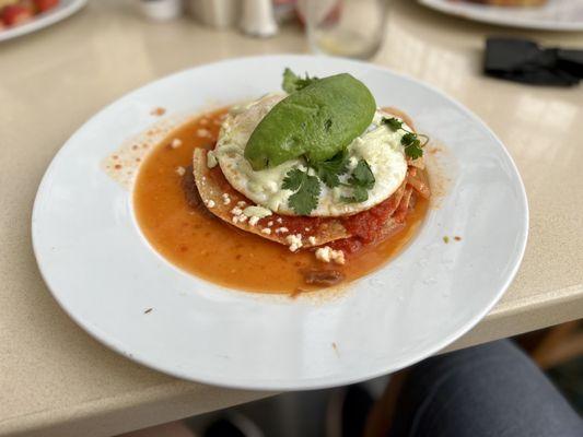 Huevos Rancheros - crisp corn tortillas, refried beans, topped with over-easy eggs, crema, queso fresco, and avocado