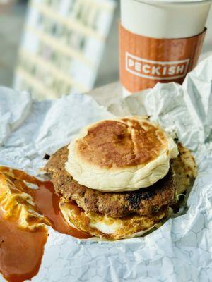 Chicken sausage breakfast sandwich with two eggs and cheddar on a Portuguese bun.