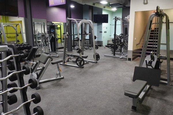 Free weight area with multiple squat racks, benches, dumbbells, and more