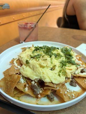 Red chilaquiles with scrambled eggs and carne asada