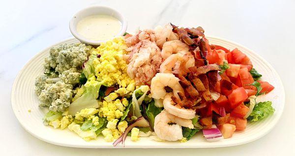 We serve lunch Wednesday through Sunday 11am-3pm. This beauty is our 1/2 size Seafood Cobb Salad with house made bleu cheese dressing.