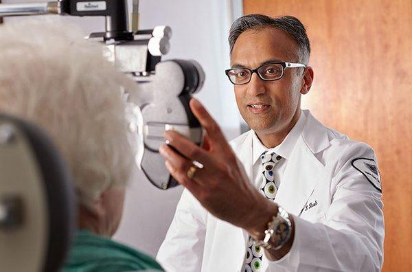 Dr. Sajay Shah visiting with a patient.