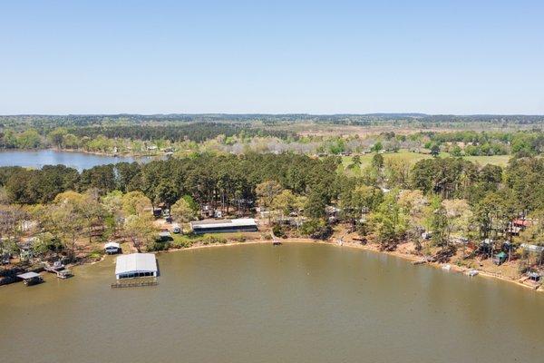 Aerial view of the park with marina  on the left and the large lakefront 4 bedroom home to right of the marina