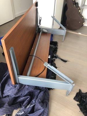 Our motorized office desk completely destroyed, steal metal legs broken in half!