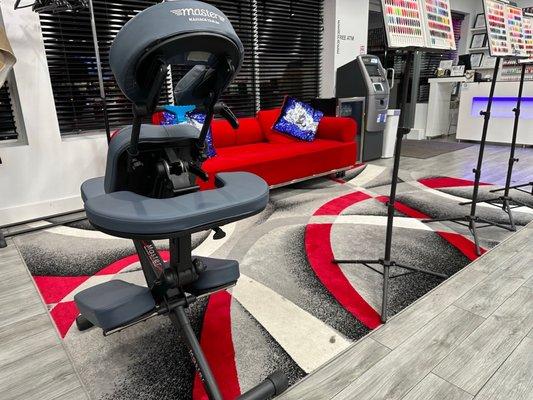 Cool waiting area with red couch and modern rug