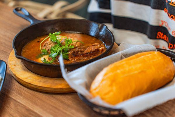 This sizzling hot pan of meat and sauce comes with crusty bread--pure indulgence in every bite.