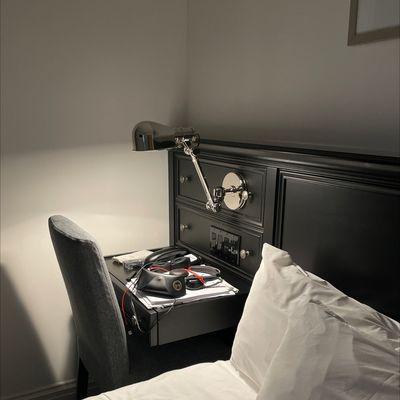 Bed with tiny desk and plenty of plugs