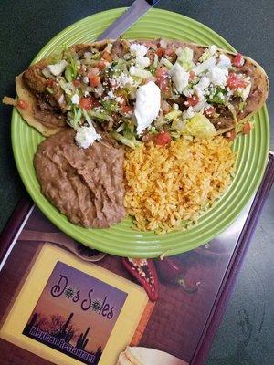 Huarache.this plate is call the sandel because of its shape it's like agordita but 3 x biger Choice of.Carnitas . Chile verde or colorado