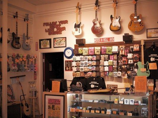 What you'll see when you walk into the store, wall of guitar strings, case full of pedals, and other guitar accessories. 
PC: Jay Connor