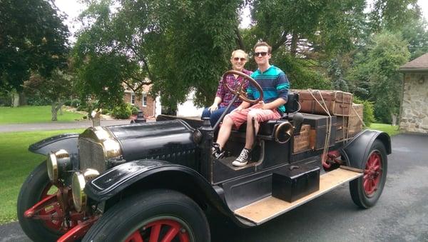 The boss's son and his girlfriend having fun with the 1919 White truck