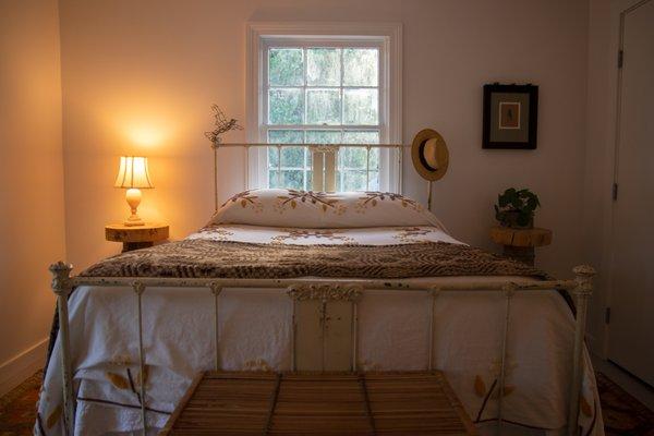 The bedroom located in the apartment on the second floor of our Art Cottage that houses artists, interns and more during their time with us.