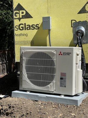 Outdoor heat pump for a Mitsubishi mini split HVAC system.